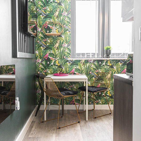 image of dining and lounge area in phoenix collection apartment showing a tv and sitting area